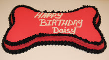 Load image into Gallery viewer, Bone cake made with peanut butter and banana, pink and black frosting.